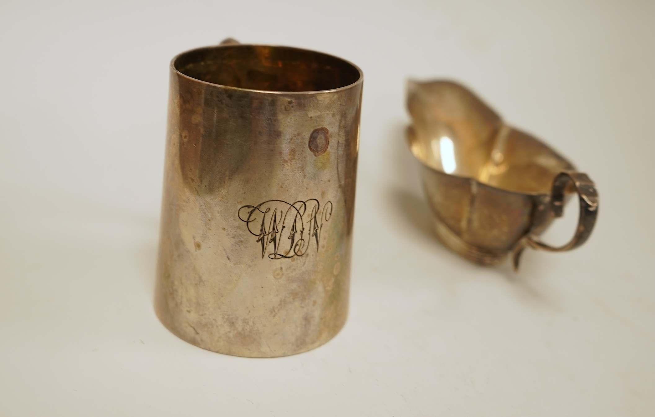 A late Victorian silver christening mug by Aldwinckle & Slater, London, 1893, height 71mm, together with a small silver sauceboat, 5oz.